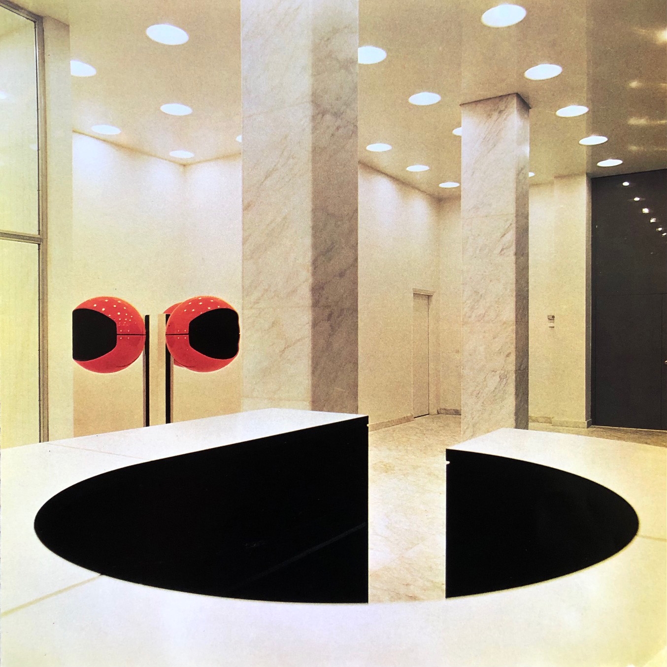 Lobby with reception desk and red telephone cabinets designed by Andr&eacute; Monpoix and Alain Richard.